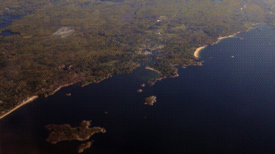 Aerial view of Widow's Bay and its dark coastline